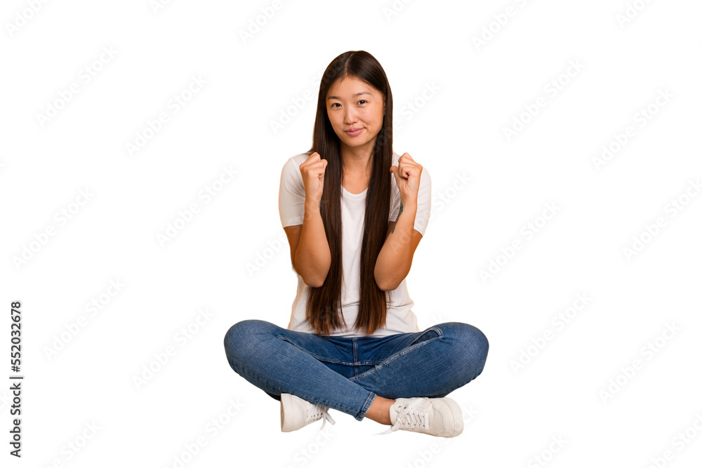 Young asian woman sitting on the floor cutout isolated feels proud and self confident, example to follow. Young asian woman sitting on the floor cutout isolated feels proud and self confident, example to follow.