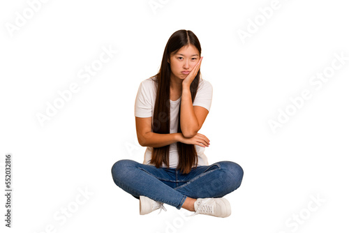 Young asian woman sitting on the floor cutout isolated who is bored, fatigued and need a relax day.