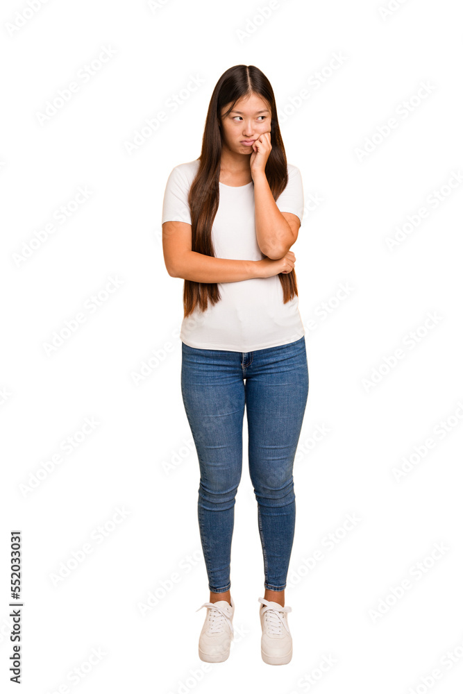 Young asian woman standing, full body cutout isolated who feels sad and pensive, looking at copy space. Young asian woman standing, full body cutout isolated who feels sad and pensive, looking at copy space.