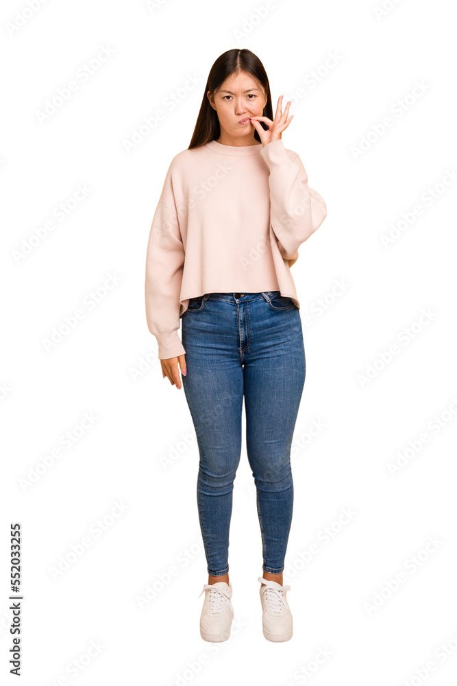Young asian woman standing, full body cutout isolated with fingers on lips keeping a secret. Young asian woman standing, full body cutout isolated with fingers on lips keeping a secret.