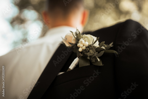 groom with flower decoration on his jacket