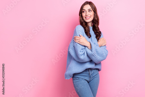 Photo of gorgeous cheerful lady arms hug shoulder look empty space isolated on pink color background