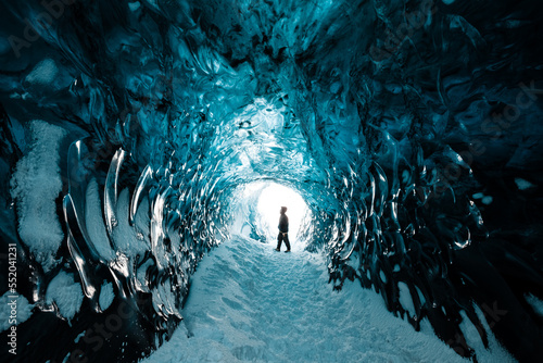 Person is standing in beautiful ice cave in Vatnajkull glacier Iceland in the winter photo