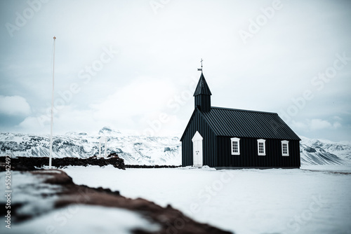 Bakirkja, Snfellsnes Peninsula, Iceland, Black church surrounded by snow, frozen nature and mountains