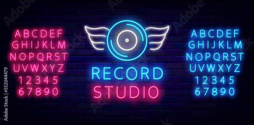 Record studio neon sign. Musical badge. Blue disk with wings. Shiny blue and pink alphabet. Vector stock illustration