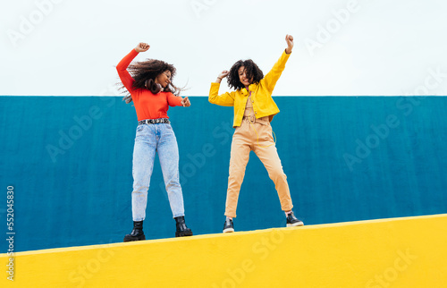 Young happy women dancing and having fun outdoor