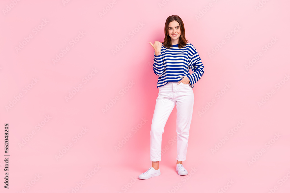 Full length portrait of nice lovely person toothy smile indicate thumb finger empty space isolated on pink color background Full length portrait of nice lovely person toothy smile indicate thumb finger empty space isolated on pink color background