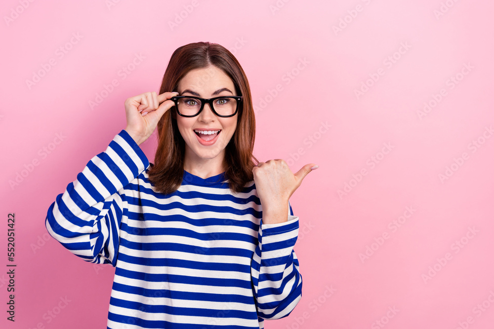 Photo of cheerful lady wear trendy sailor print clothes demonstrate empty space cool offer propositions isolated on pink color background Photo of cheerful lady wear trendy sailor print clothes demonstrate empty space cool offer propositions isolated on pink color background