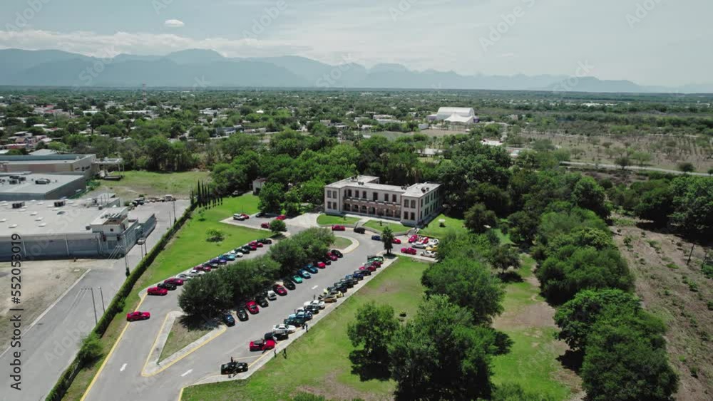 AERIAL - Buildings and mountain range, Montemorelos, Nuevo León, Mexico, spinning shot AERIAL - Buildings and mountain range, Montemorelos, Nuevo León, Mexico, spinning shot