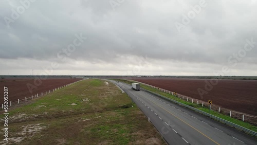 AERIAL - Truck on empty highway, cloudy day, Reynosa, Tamaulipas, Mexico, forward photo