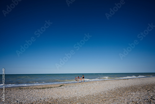 Family with kids swimming in Adriatic sea at beach Porto Sant Elpidio, Italy.