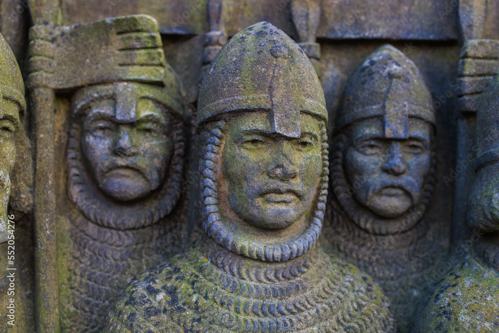 Ancient bas-reliefs in the architecture of the city. Historical and cultural heritage. Background with selective focus Ancient bas-reliefs in the architecture of the city. Historical and cultural heritage. Background with selective focus