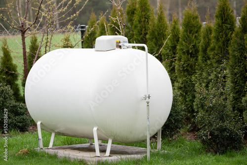 Propane gas tank for home heating. Gas supply for heating the building. photo