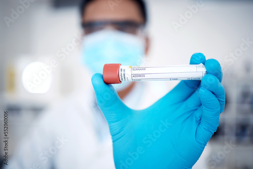 Closeup, test tube and lab for dna results, experiment and in laboratory with gloves for protection. Male scientist, man and medical for safety for virus, sickness or blood sample for cure or illness