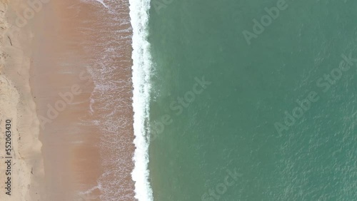 drone shot over waves crashing on a sandy beach coast Basque province of Labourd France