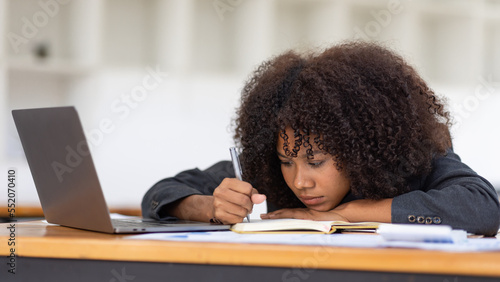 Feeling tired and stressed, workload, burnout and fatigue. Frustrated young african american woman keeping eyes closed and massaging nose after work at laptop for long time in office