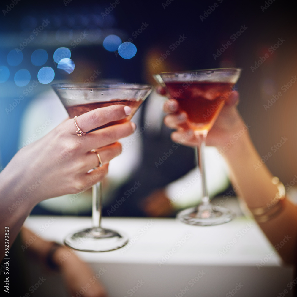 Hands, cocktail and party with friends drinking together in a nightclub for a new year celebration. Glass, toast and event with a female and friend celebrating with a cheers in a music club or disco Hands, cocktail and party with friends drinking together in a nightclub for a new year celebration. Glass, toast and event with a female and friend celebrating with a cheers in a music club or disco