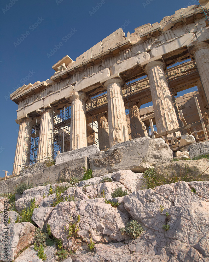 Extreme perspective of the western front of Parthenon ancient temple under a clear blue sky. A visit to Acropolis of Athens, Greece.