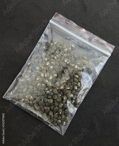 close-up of okra seeds in a package,package full of okra seeds on a black background,
