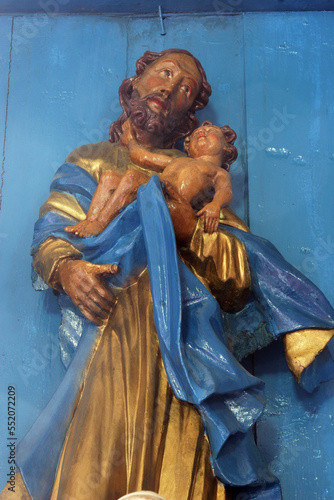 Saint Joseph holding the baby Jesus, statue on the Altar of Saint Joseph in the Parish Church of the Assumption of the Virgin Mary in Gornja Rijeka, Croatia