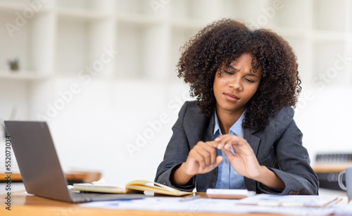 african american girl woman holding her wrist pain from using computer. Office syndrome hand pain by occupational disease.