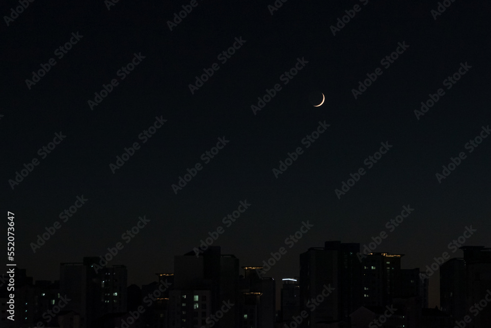 Crescent moon in the night sky.