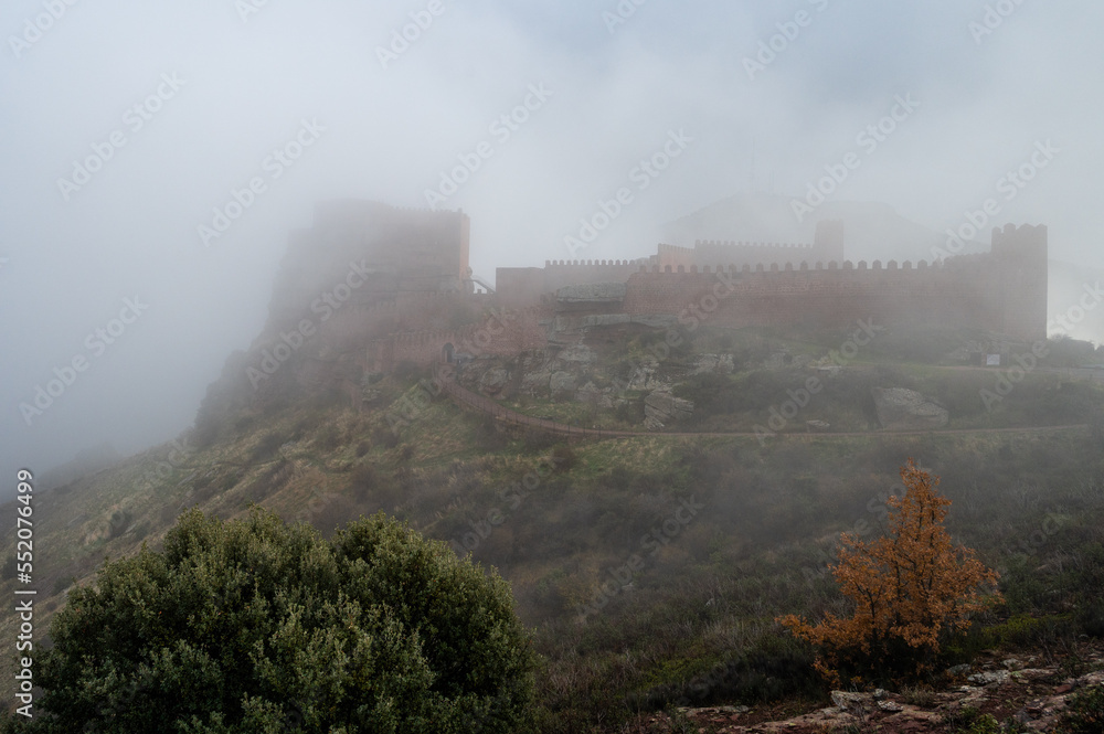 Obraz premium View of the Peracense Castle during an Autumn day with mist. Teruel, Aragon, Spain.