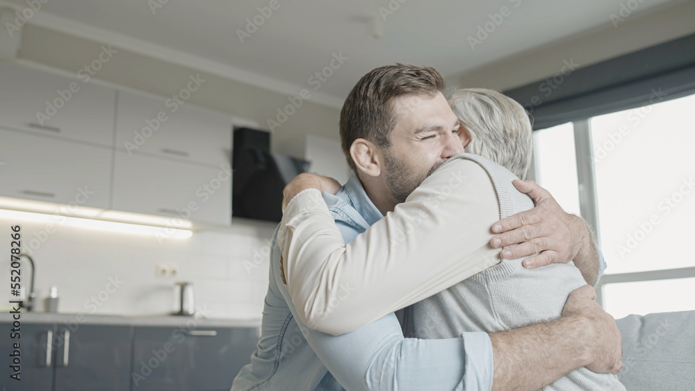 Senior father hugging adult son, family, togetherness, close relationship