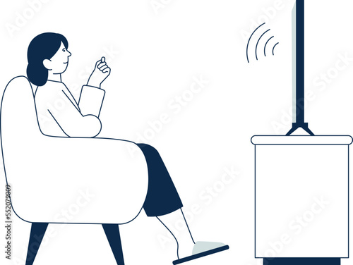 Woman sit on armchair and watching tv side view