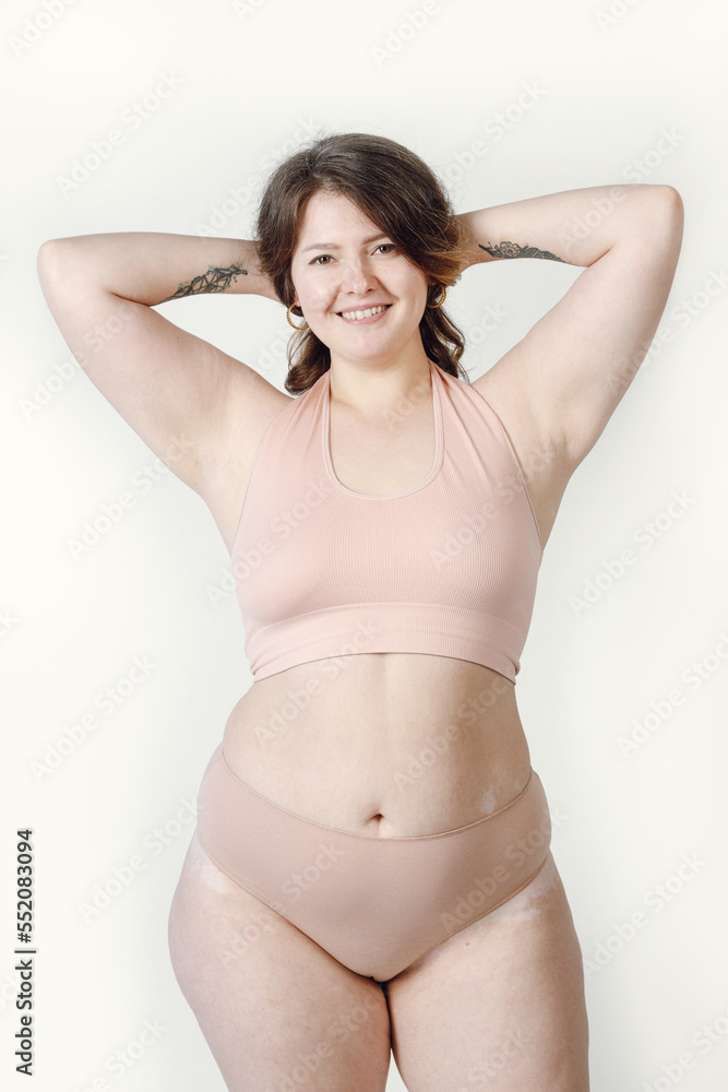 A Smiling Woman Of Large Sizes In Underwear A Plump Girl On A Light a-smiling-woman-of-large-sizes-in-underwear-a-plump-girl-on-a-light