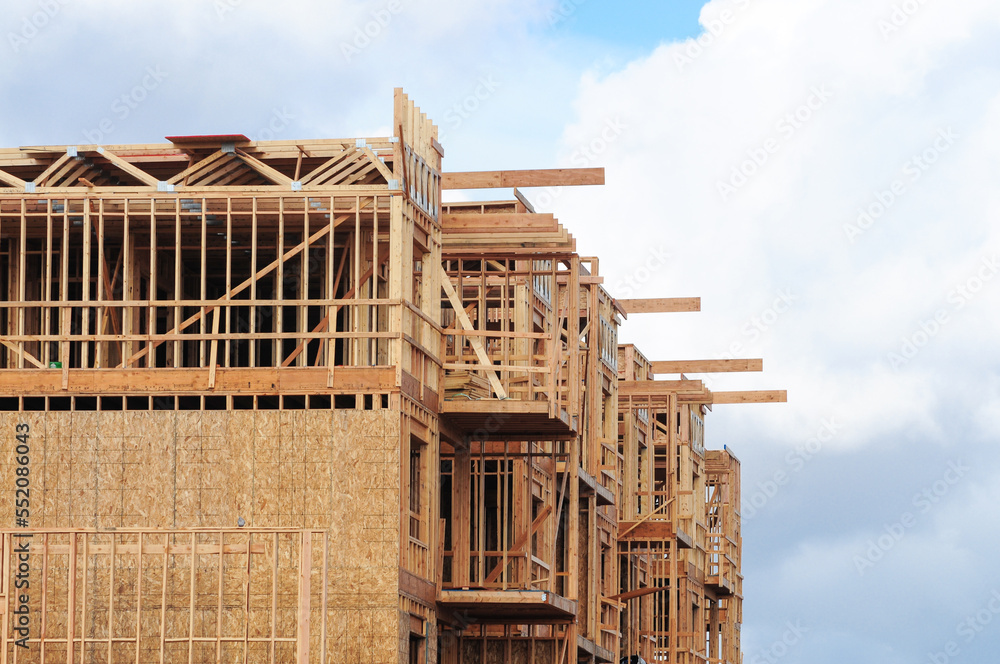 Structural wooden frame of apartment building under construction Structural wooden frame of apartment building under construction