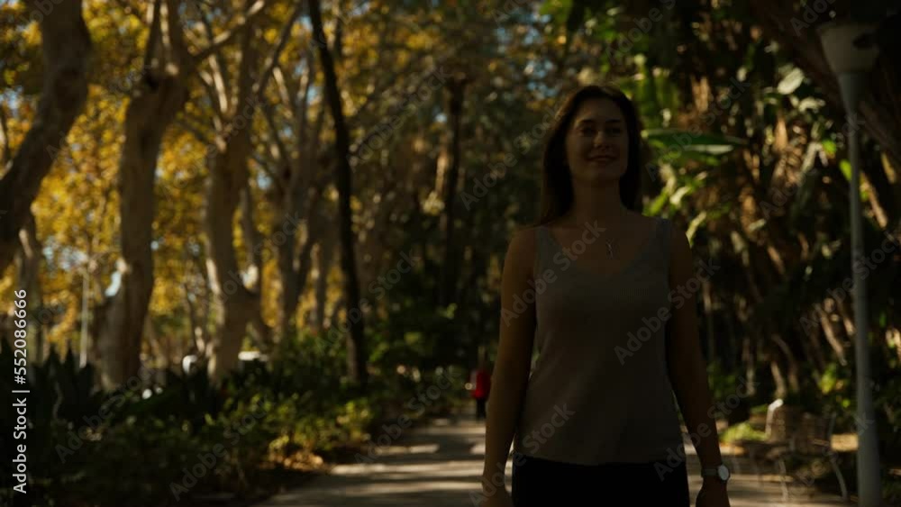 young tourist woman walking through the gardens of the city of Malaga young tourist woman walking through the gardens of the city of Malaga