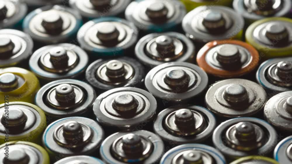 Preparing Batteries for Disposal. Dense AA battery array moves with slight rotation close-up with backlight Preparing Batteries for Disposal. Dense AA battery array moves with slight rotation close-up with backlight