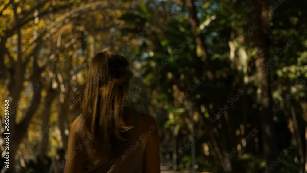 young tourist woman walking through the gardens of the city of Malaga young tourist woman walking through the gardens of the city of Malaga
