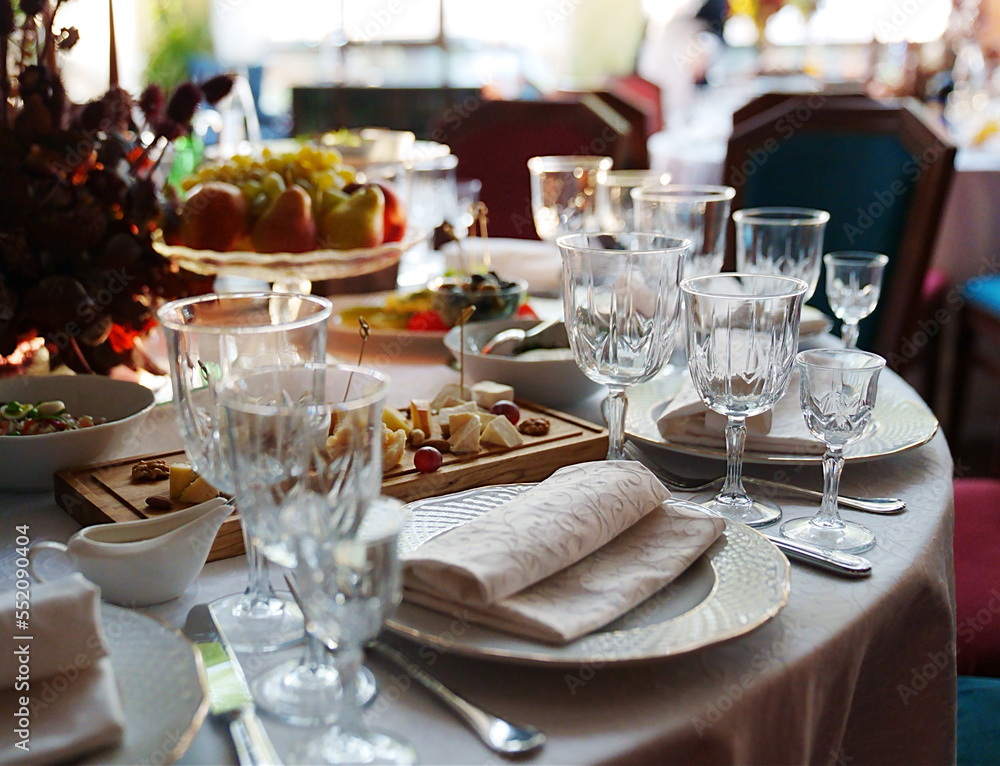 table setting for a festive dinner. empty wine glasses, tableware and snacks. table setting for a festive dinner. empty wine glasses, tableware and snacks.