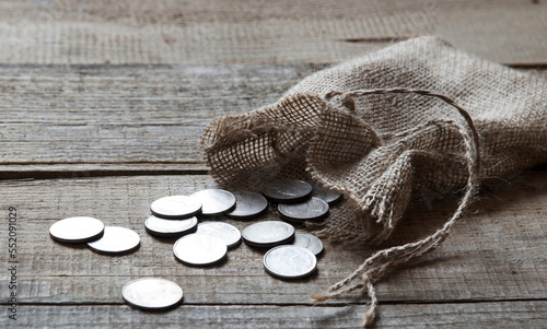 Fotografie, Tablou Thirty coins in a bag on the table