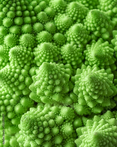 Green vegetable background of Romanesco cabbage. Romanesco cabbage close-up. Agricultural business. Growing vegetables. Plant growing.