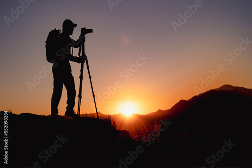 photographer shooting with tripod at sunrise
