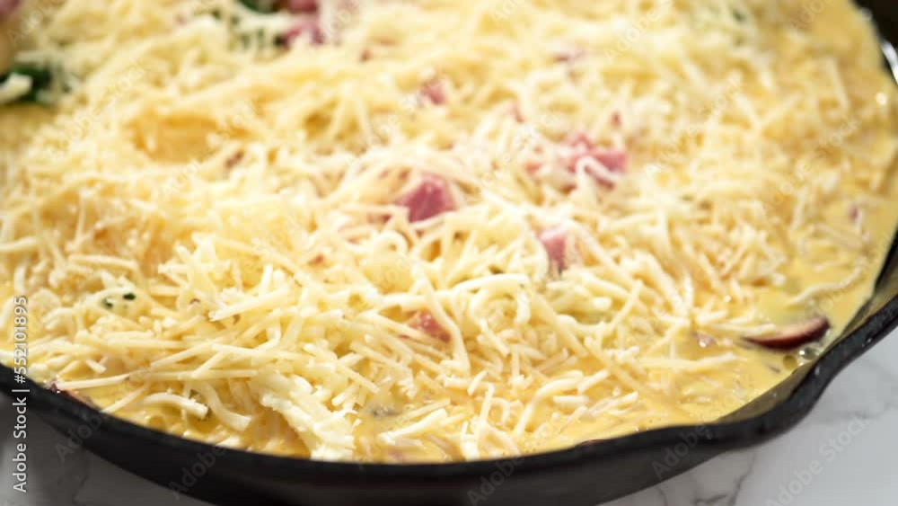 Preparing spinach and ham frittata in cast iron skillet. Preparing spinach and ham frittata in cast iron skillet.