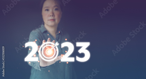 2023 goal and target. Hand touch dartboards with 2023 number with copy space for text. Concept of new year, start up business. Beginning strategy and plan for future, Business management and financial photo