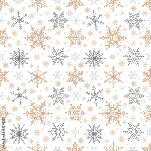 Seamless Christmas pattern of gold and silver snowflakes. Vector illustration.