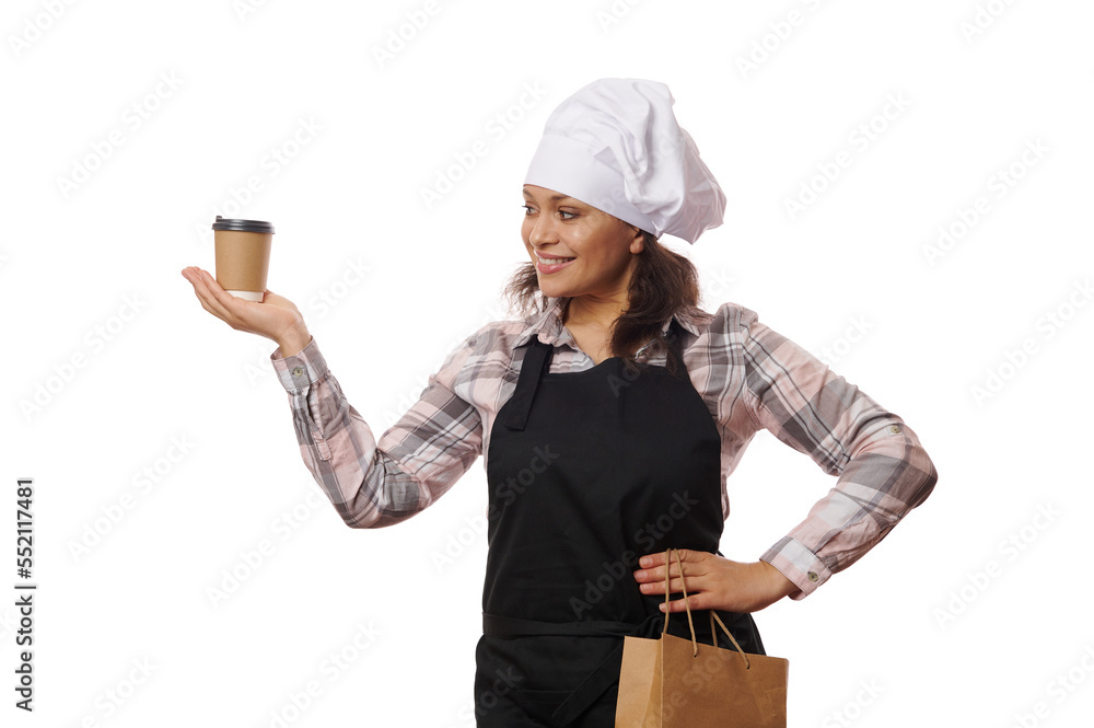 Grocery store employees. Small business and coffee shops concept. Friendly smiling woman barista holding takeaway drink in paper cup, looking left dreamy as serving order to clients, white background Grocery store employees. Small business and coffee shops concept. Friendly smiling woman barista holding takeaway drink in paper cup, looking left dreamy as serving order to clients, white background