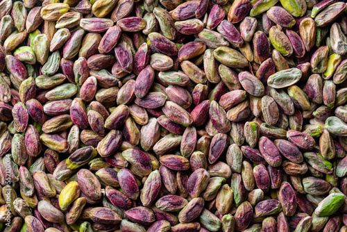 Pile pistachio kernels nuts without shell, closeup. Pistachios without shell, top view. Whole nut kernels