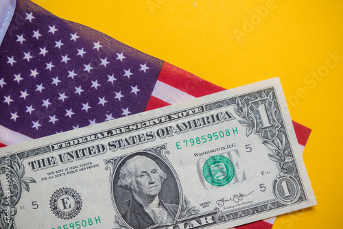 A United States One Dolalr Bill and US Flag photo