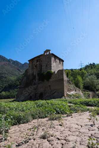 View of the Baells Reservoir and the mountains around it during dry season. Dry dam with small river passing trough. Monestery of Sant Salvador de la Vedella in the middle photo