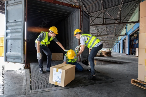 Worker carry carton box taken from 40 feet steel container got accident drop box to floor injury photo