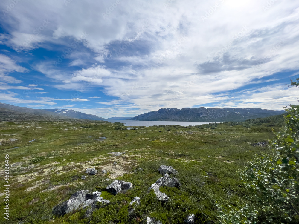 Norwegian landscape with, mountains, a lake , sky and clouds