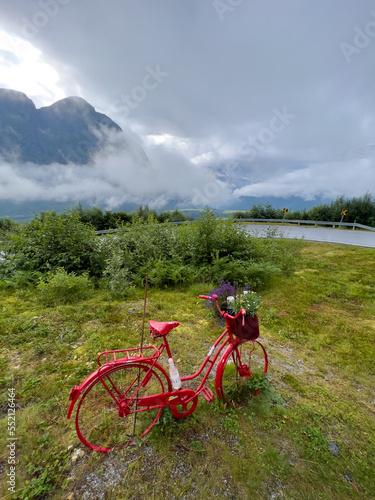 old red bicycle near a mountainroad in Norway