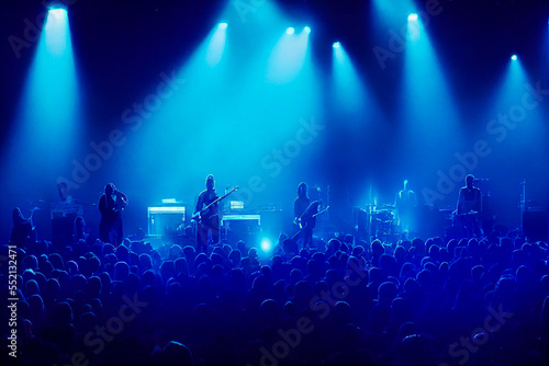 Silhouette of a crowd vibrating in the blue, under the rock rhythm. A scene rich in color and energy, captured under blue lights and smoke. Ideal for visual dynamism.