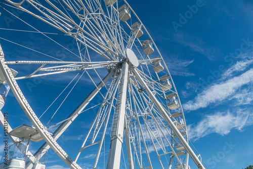 Big ferris wheel agains a blue sky with white clouds in Luino